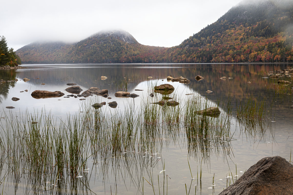 Jordan Pond on an overcast day with low clouds hiding the top of the two Bubbles. North Bubble on the left is mostly hidden and south Bibble is just to the right. [J20R2333]