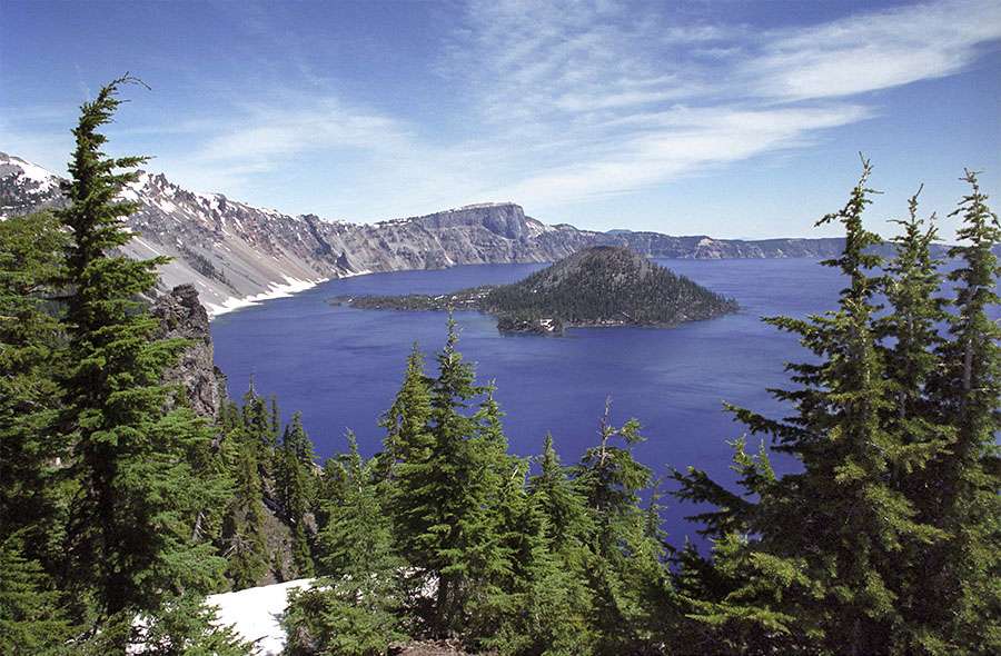 Crater Lake gets 533 inches (44.4 ft) of snow in an average year, but got only 360 inches in the year ending 30 June 2005. Only rainfall and snow feed the lake. This results in water that is extremely clear. The depth and clarity of the water is responsible for the intense blue color that is so captivating. It's why some people call this the most beautiful lake in the world.