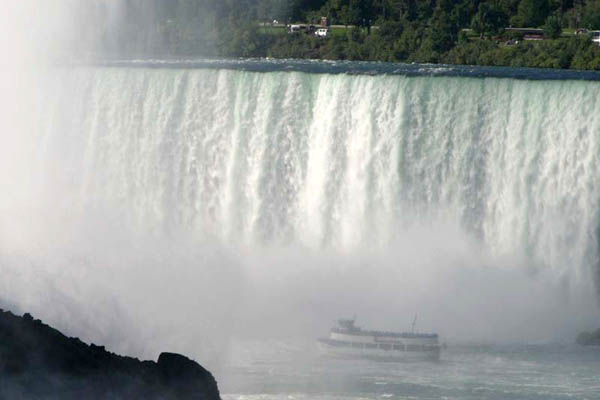 Maid of the Mist boat at the bottom of the Horseshoe Falls is almost lost in the mist.