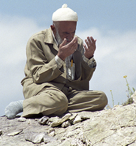 Man praying near the Ishak Pasa Palace