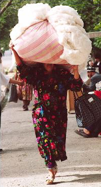 Woman carrying bundle of cotton